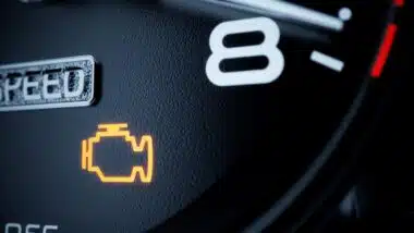 Close up of an illuminated engine light, representing the GM engine failure investigation.