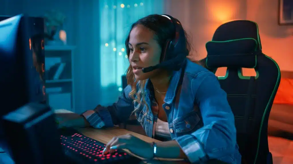 Girl playing video games on PC.