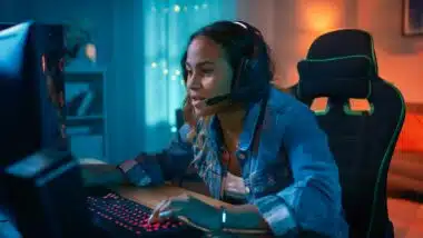 Girl playing video games on PC.