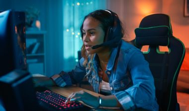 Girl playing video games on PC.