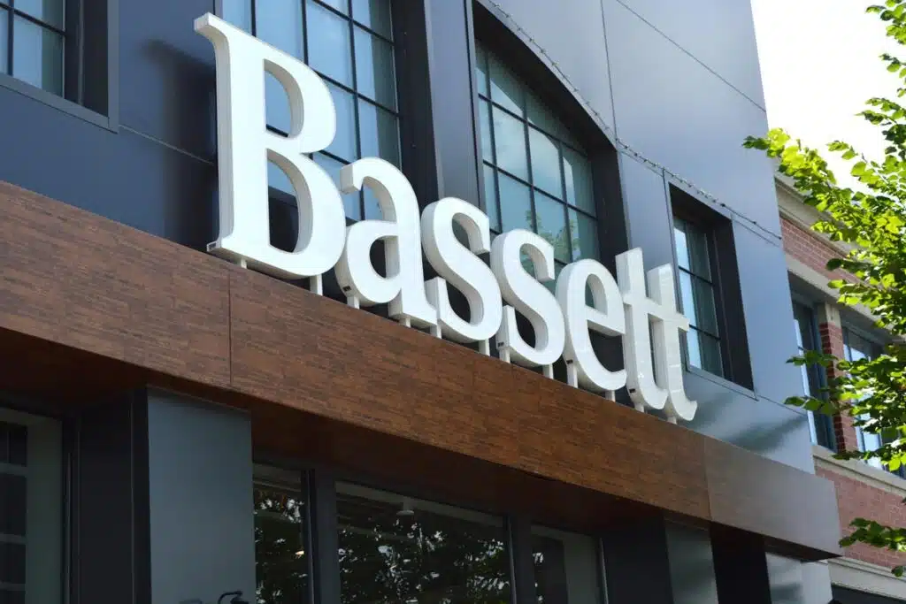 Close up of Bassett storefront signage, representing the Bassett Furniture settlement.