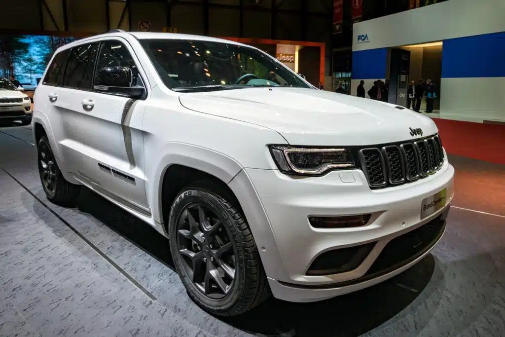 A White Grand Jeep Cherokee at a car show, representing the Jeep Cherokee recall.