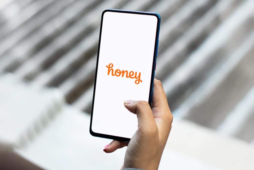 Honey logo displayed on a smartphone screen, representing the PayPal honey web extension class action lawsuit.