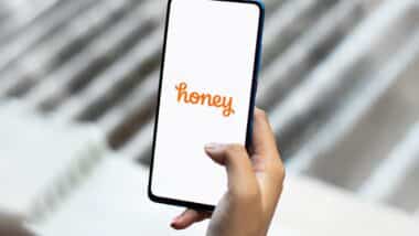 Honey logo displayed on a smartphone screen, representing the PayPal honey web extension class action lawsuit.