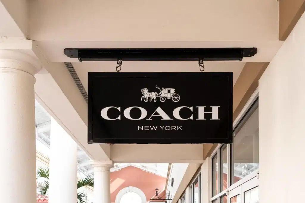 Close up of Coach store signage, representing the Coach Outlet class action.