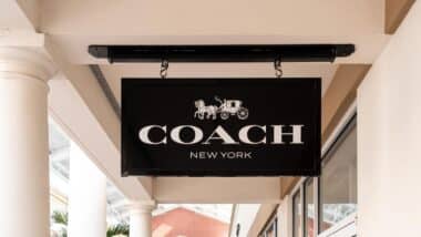 Close up of Coach store signage, representing the Coach Outlet class action.