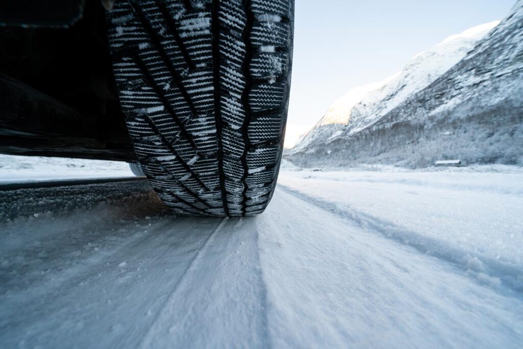 Close up of an auto tire driving on a snowy road, representing the Prinx Chengshan class action.