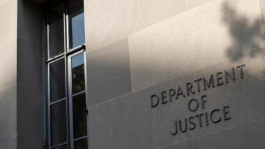 U.S. Department of Justice headquarters signage, representing the U.S. Victims of State Sponsored Terrorism Fund to victims.