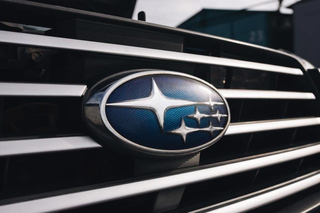 Close up of Subaru emblem on a front bumper, representing the Subaru settlement.