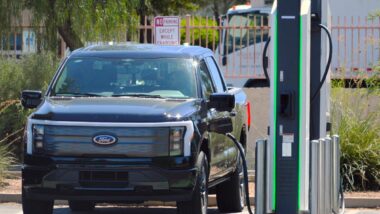 A Ford F-150 Lightning at a charging station, representing the Ford recall.