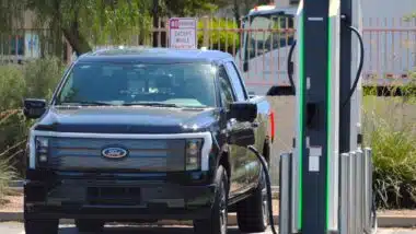 A Ford F-150 Lightning at a charging station, representing the Ford recall.