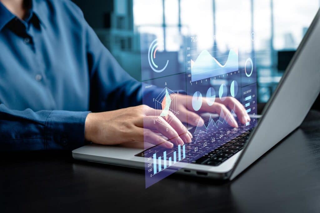 Close up of hands typing on a laptop with a data overlay, representing the AUS settlement.