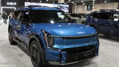 A blue Kia EV9 at a car show, representing the Kia recall.