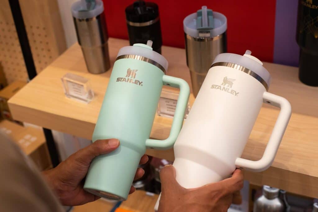 A customer holding Stanley drinkware, representing the Stanley class action.