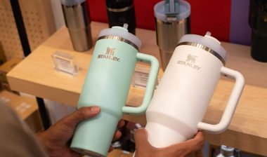 A customer holding Stanley drinkware, representing the Stanley class action.