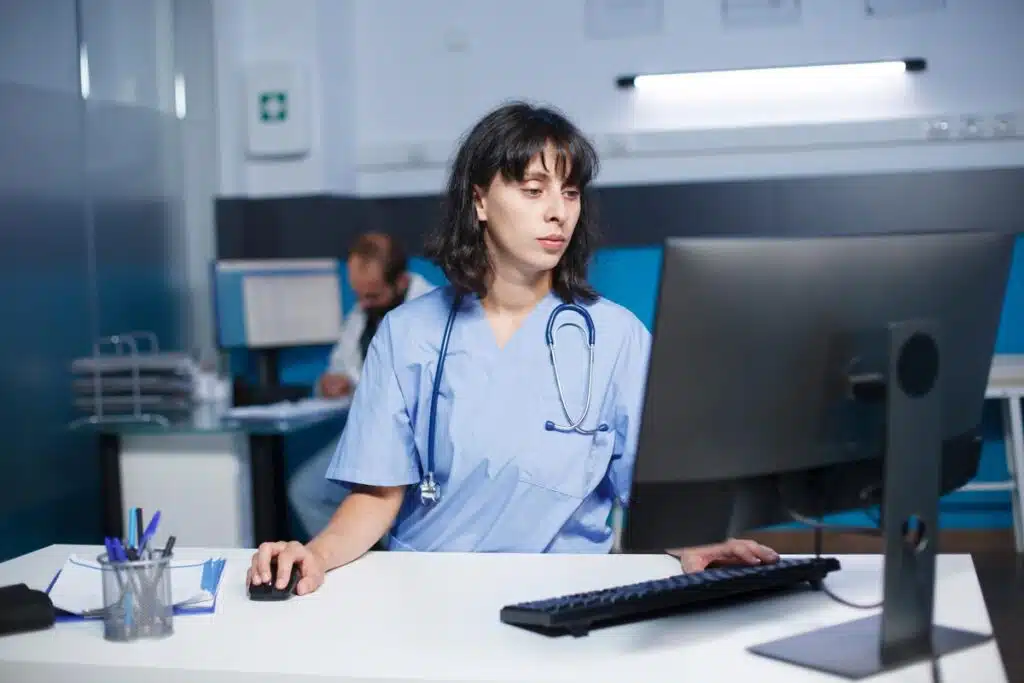 A nurse using a computer in a hospital, representing the McPherson Hospital settlement.
