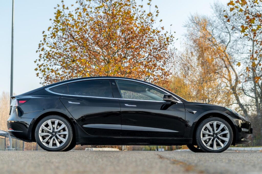 A black Tesla, representing the Tesla Actually Smart Summon feature.