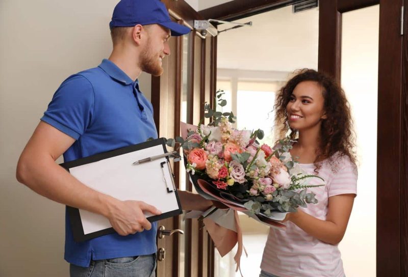An employee delivering a floral arrangement,representing the FTD class action.