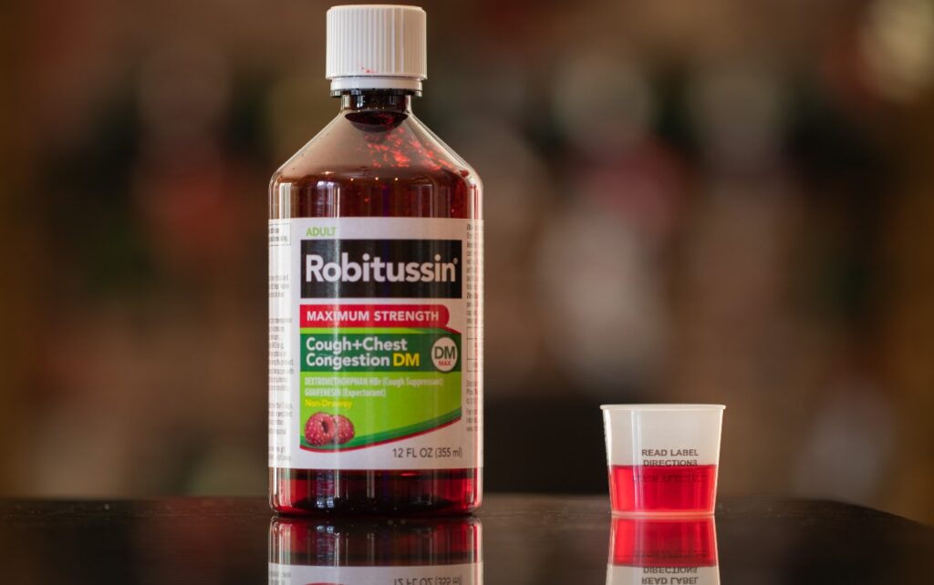 Robitussin Maximum Strength Cough + Chest Congestion DM with blurry background