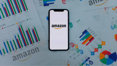 Iphone 11 pro with the Amazon logo. on top of charts