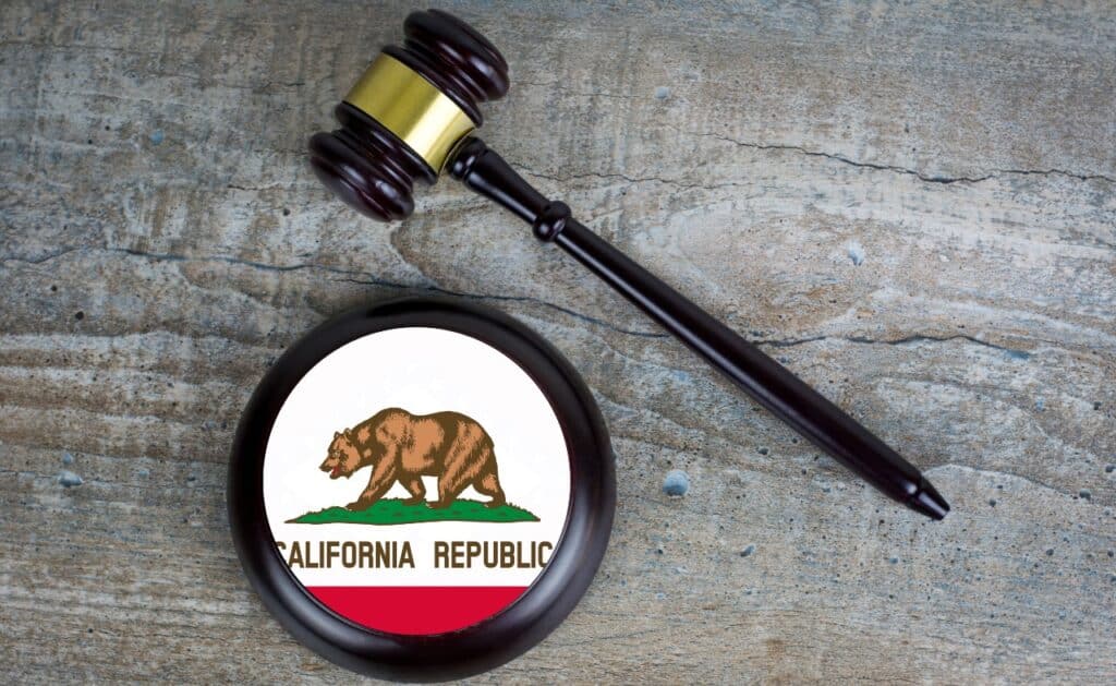 Wooden judgement or auction mallet with of California flag.