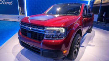 A red 2022 Ford Maverick on display at a car show, representing the Ford recall.