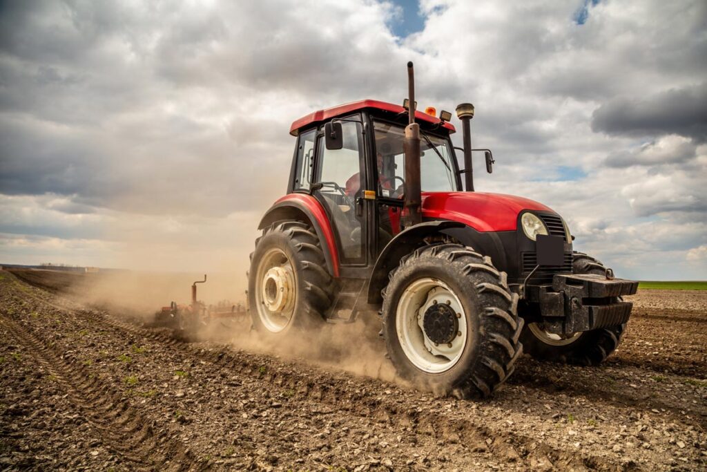 A tractor in a field, representing the Smitty's Supply and CAM2 settlement.