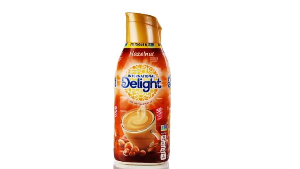 International Delight hazelnut coffee cream logo on plastic bottle isolated on white background with reflection