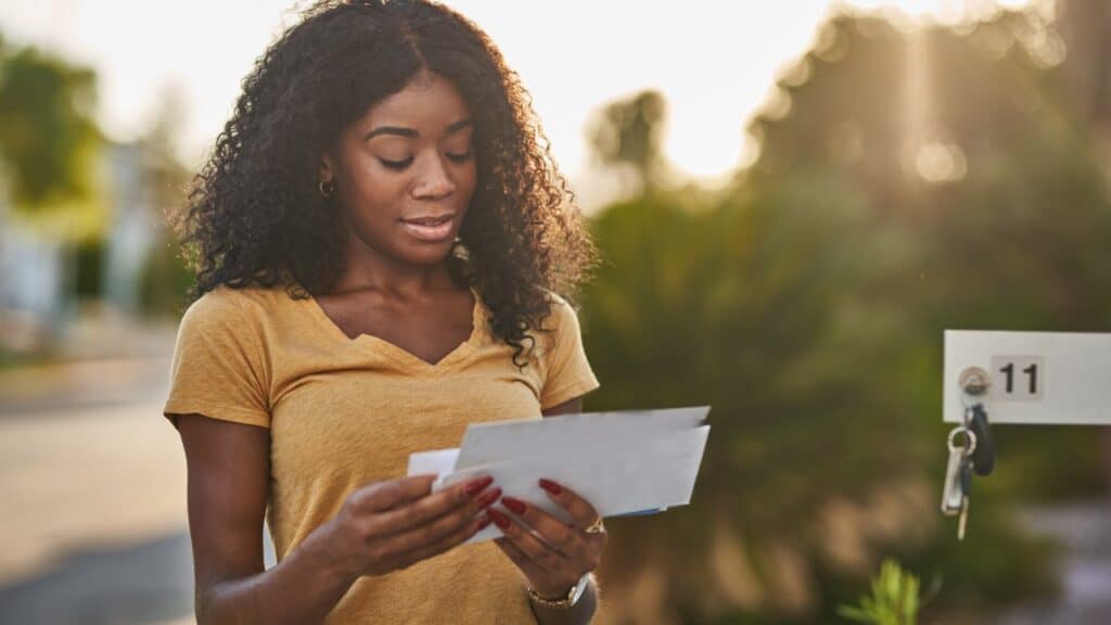Woman receiving rebate check in the mail