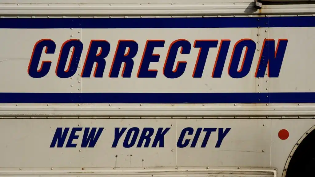 buses adorned with the New York City Correction Department signage.