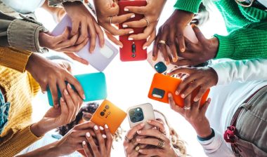 Group of young people using smart mobile phone device outside - Trendy technology concept with guys and girls on social media