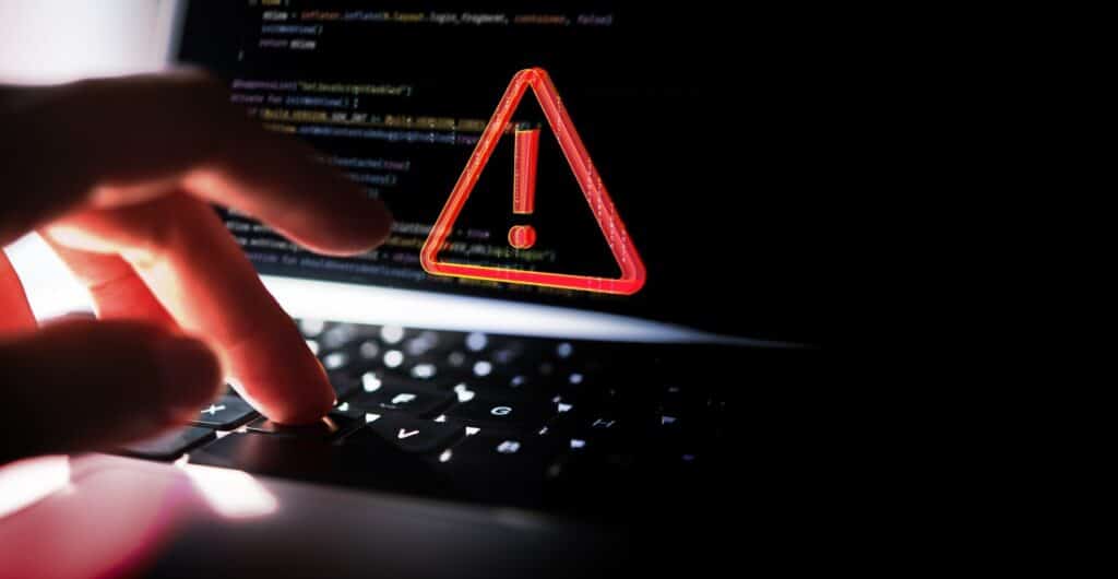 System hacked warning alert on laptop.