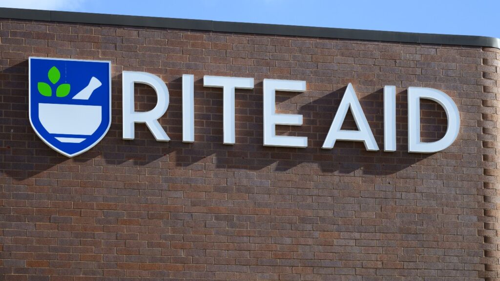 Sign on brick wall for Rite Aid wih logo an American drugstore