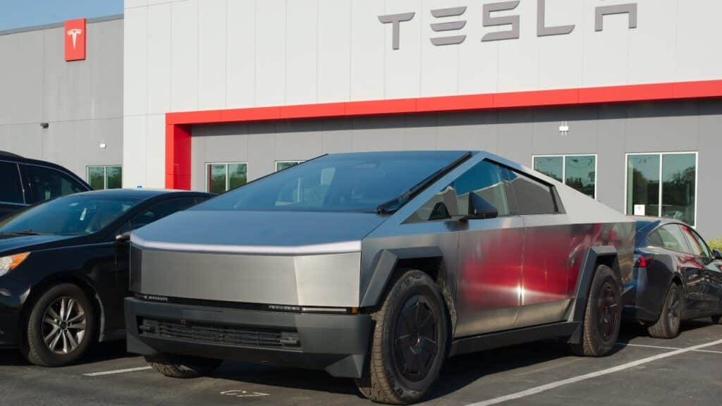 Tesla Dealership cars and signs. Late afternoon sun. Tesla Cybertruck and other vehicles.