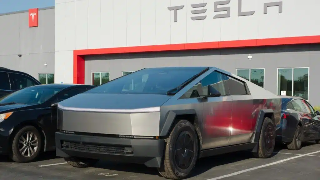 Tesla Dealership cars and signs. Late afternoon sun. Tesla Cybertruck and other vehicles.