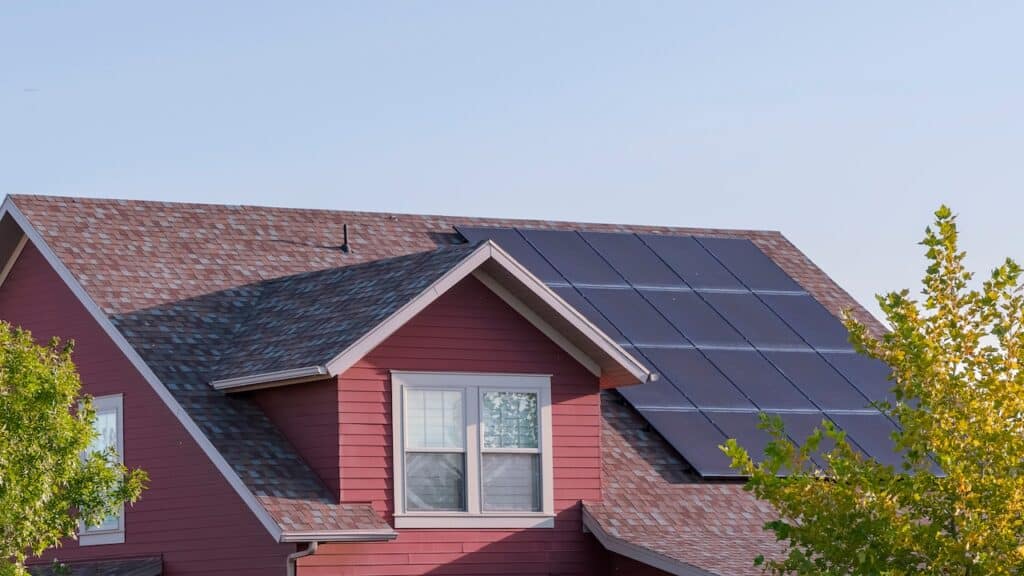 Panorama Array of photovoltaic solar panels on a roof.