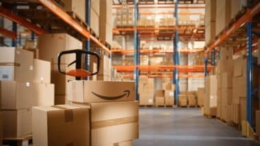 Big Warehouse Package with Amazon Logo Stacked with Cardboard Boxes