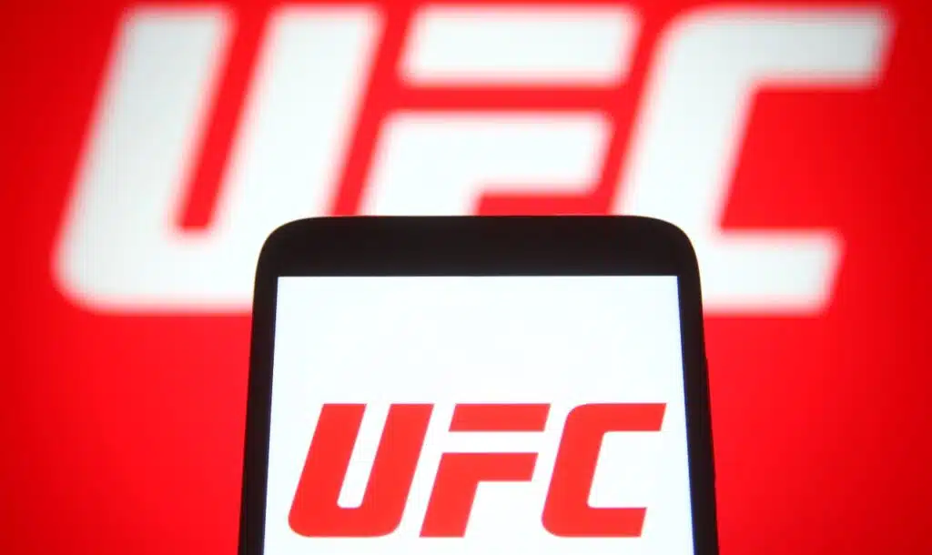 In this photo illustration Ultimate Fighting Championship (UFC) logo is seen on a mobile phone and a computer screen.