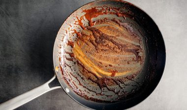 Dirty Nonstick Skillet Used to Make a Balsamic Reduction: An unwashed frying pan covered in a sticky glaze