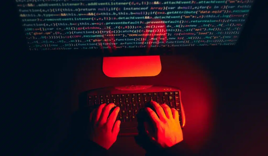 Man using computer and programming to break code
