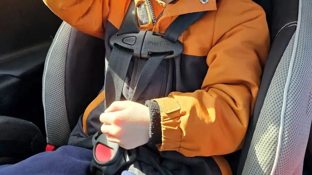 A child looking at their new toy as they sit in a car seat.
See less