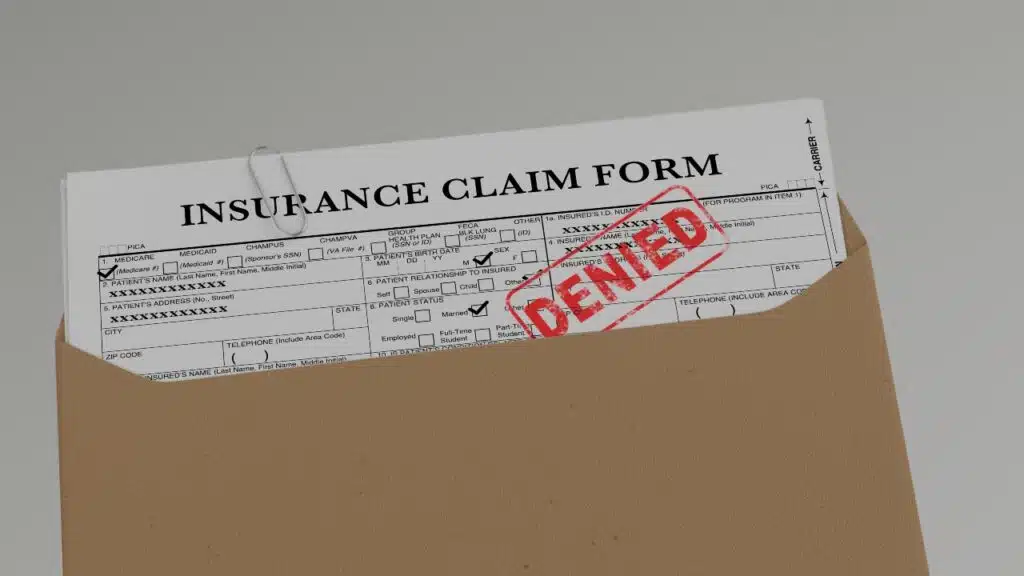 Document with denied stamp put on the wooden table