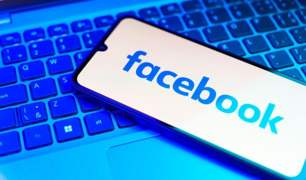 Smartphone on surface showing Facebook logo.