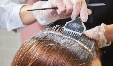 Hair dying close up. Brush applying hair color.