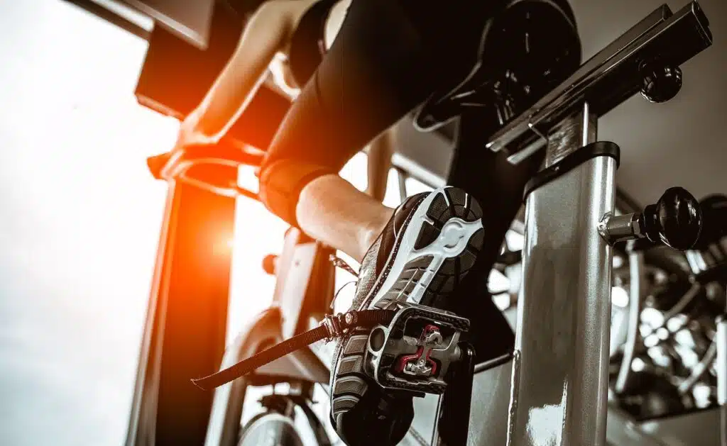 woman working out on exercise bike at the gym