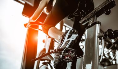 woman working out on exercise bike at the gym