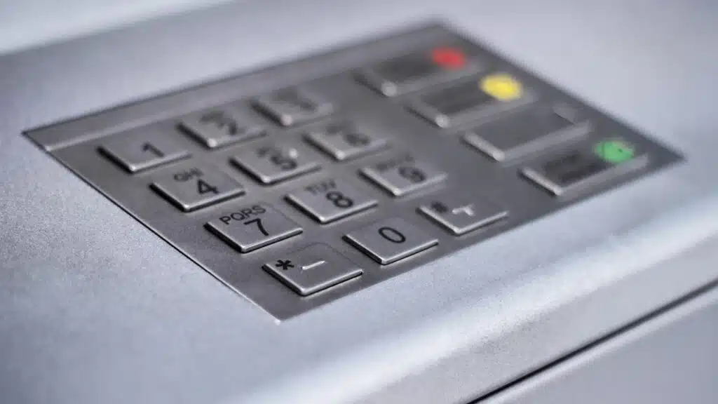 Entering personal identification number on ATM