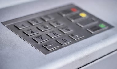 Entering personal identification number on ATM