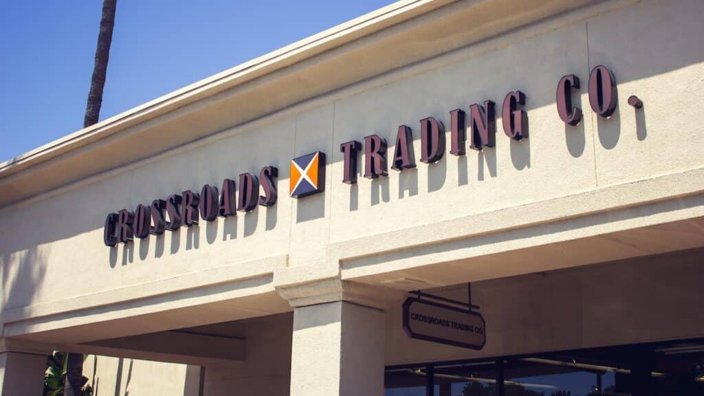 A view of a store front sign for the consignment clothing store known as Crossroads Trading Company.