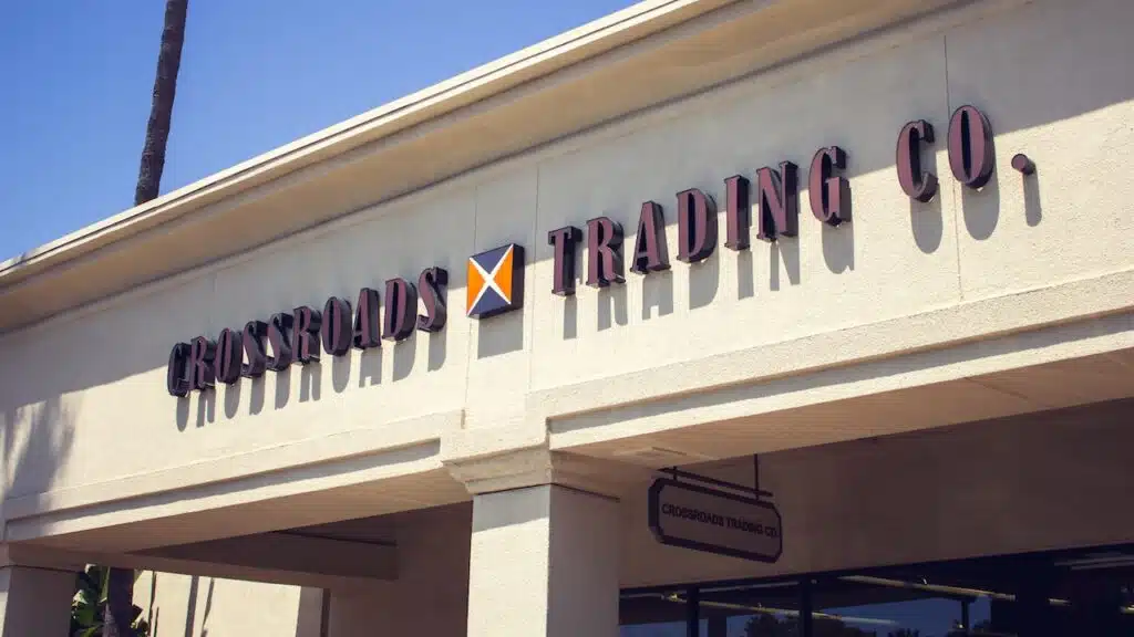 A view of a store front sign for the consignment clothing store known as Crossroads Trading Company.